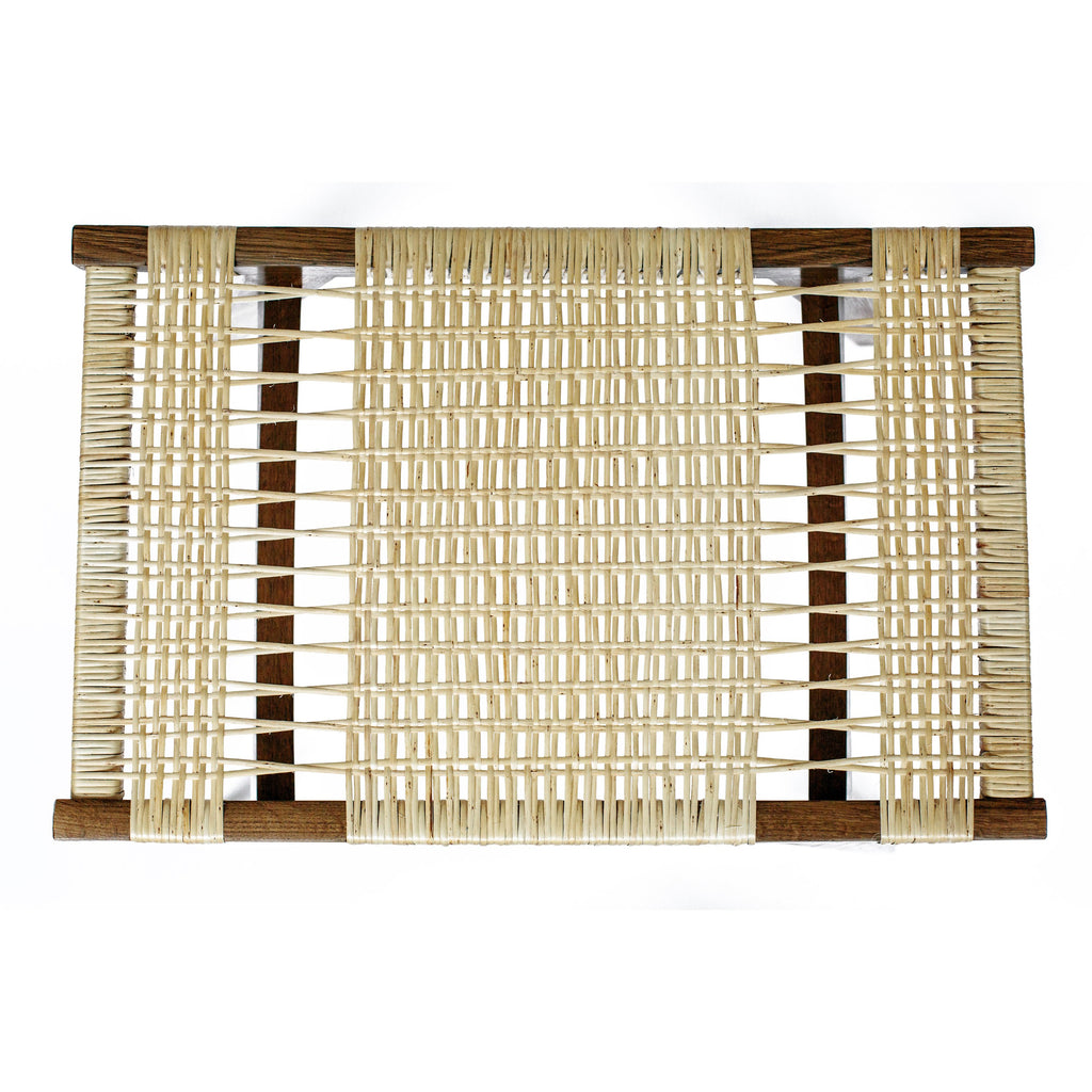 Photo of a split willow pi stool seat on a fumed oak frame, on a white background.