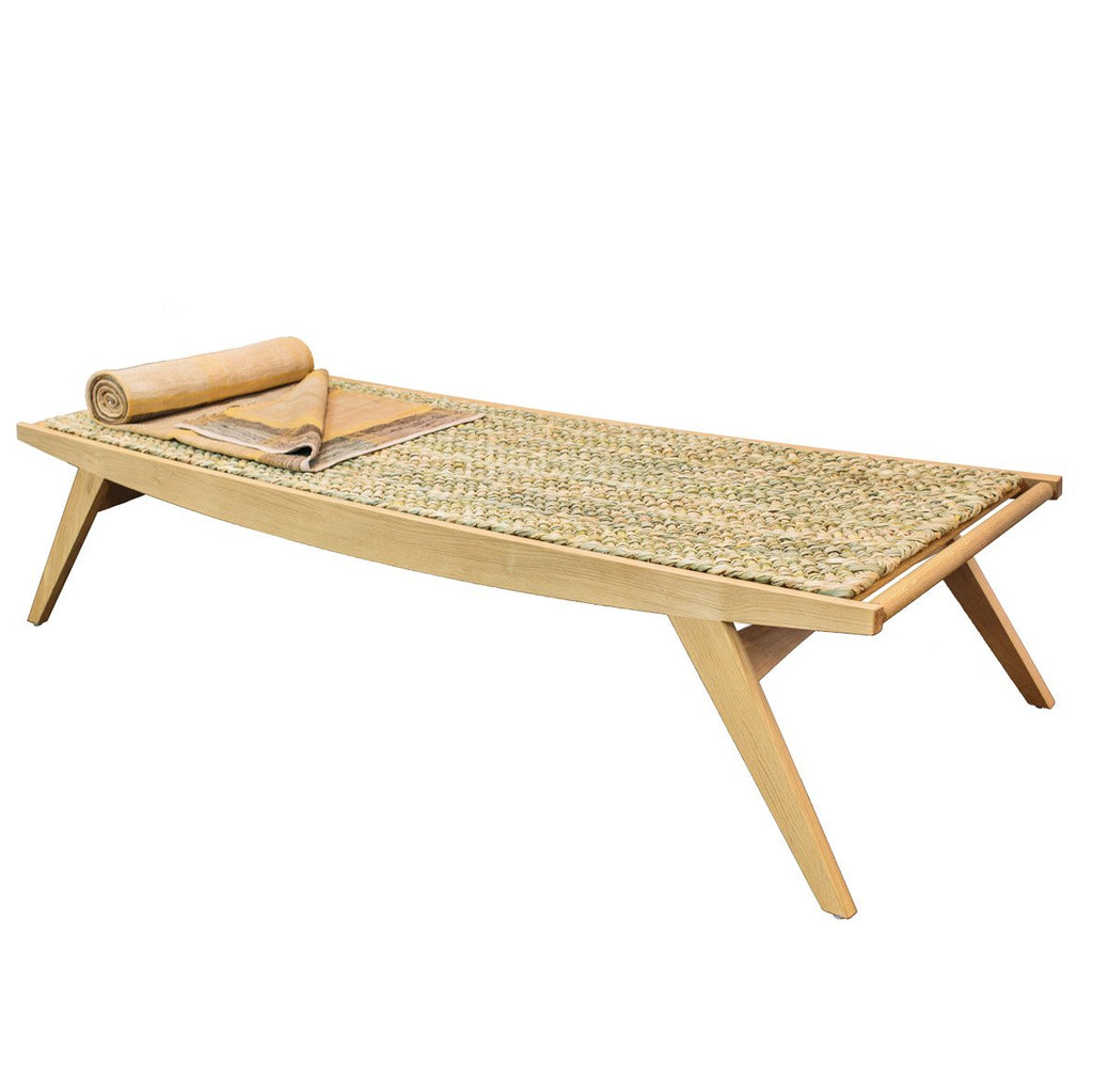 Photo of a natural oak Lambda Daybed with rush mat on a white background.