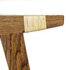 Photo close up of a fumed oak pi stool frame with split willow seat on a white background.