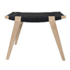 Photo of a limed oak and black Danish Cord pi stool on a white background.